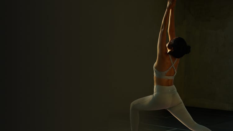 Full length of Young woman doing balancing stick pose, warrior